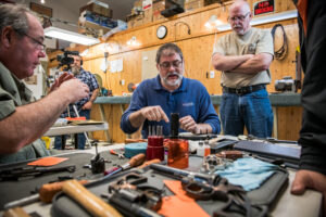A skilled gunsmith demonstrating D, F, & R techniques on a revolver handgun.